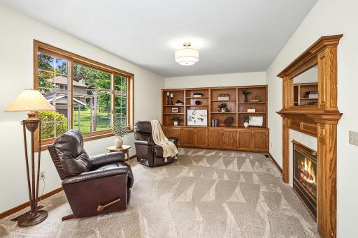 The main level family room welcomes fabulous casual living space, with a full wall of built-in cabinetry and a cozy gas fireplace.