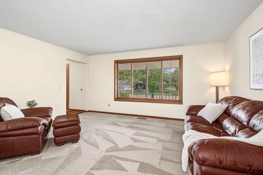 Fabulous formal living room with a large window, new neutral carpet and freshly painted walls.