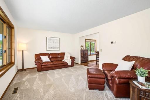 The spacious formal living room flows effortlessly into the formal dining room, perfect for entertaining.