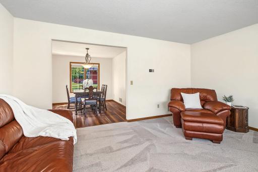 The formal dining room has multiple windows and opens to the kitchen and informal dining area.