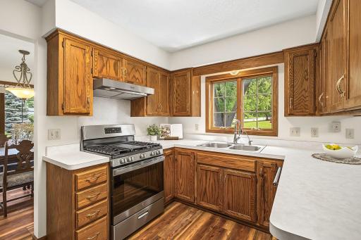 Bright and cheery kitchen with a window sink that overlooks the backyard.