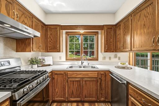 The kitchen offers stainless steel appliances, abundant cabinetry, and counter space.