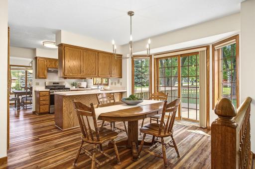 View of the informal dining area showing the elegant updated light fixture, high quality Anderson windows and sliding glass door.