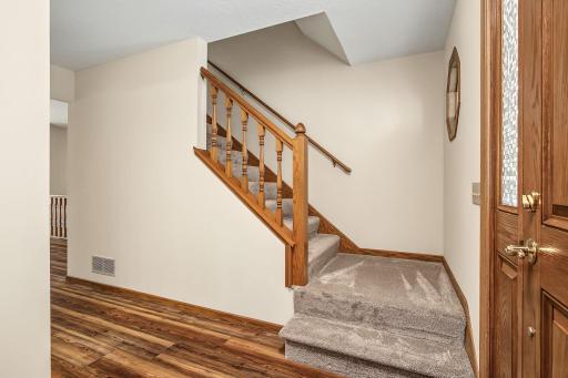 View of the foyer entrance and staircase that leads to this homes upper level.