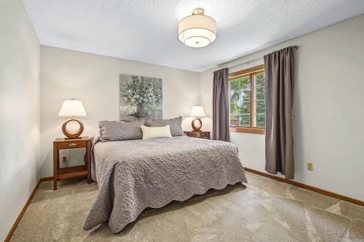 Primary bedroom with a new gorgeous light fixture, walk-in closet, and ensuite 3/4 bath.