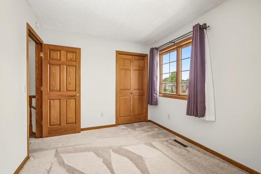 Second view of bedroom #3 that welcomes room for a growing family or guests.