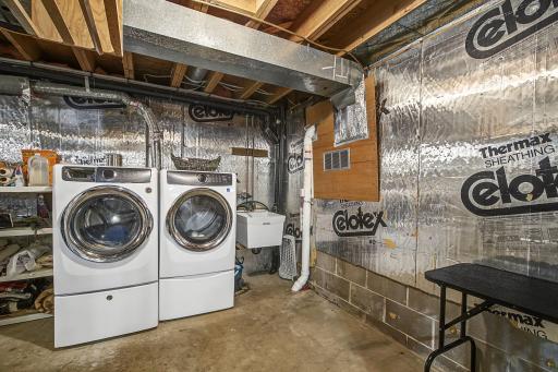 Designated laundry area with a front loading washer & dryer, convenient laundry sink, and a radon mitigation system.