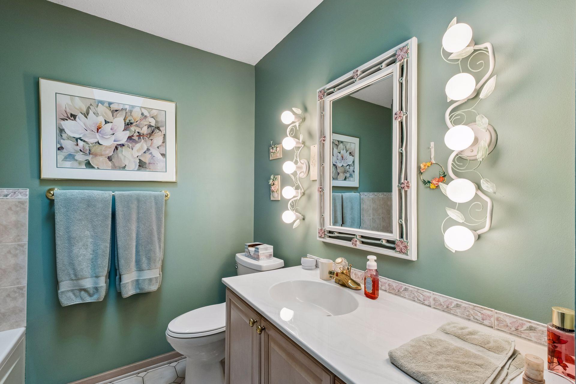 Second bathroom on upper level with jetted tub and sky light.
