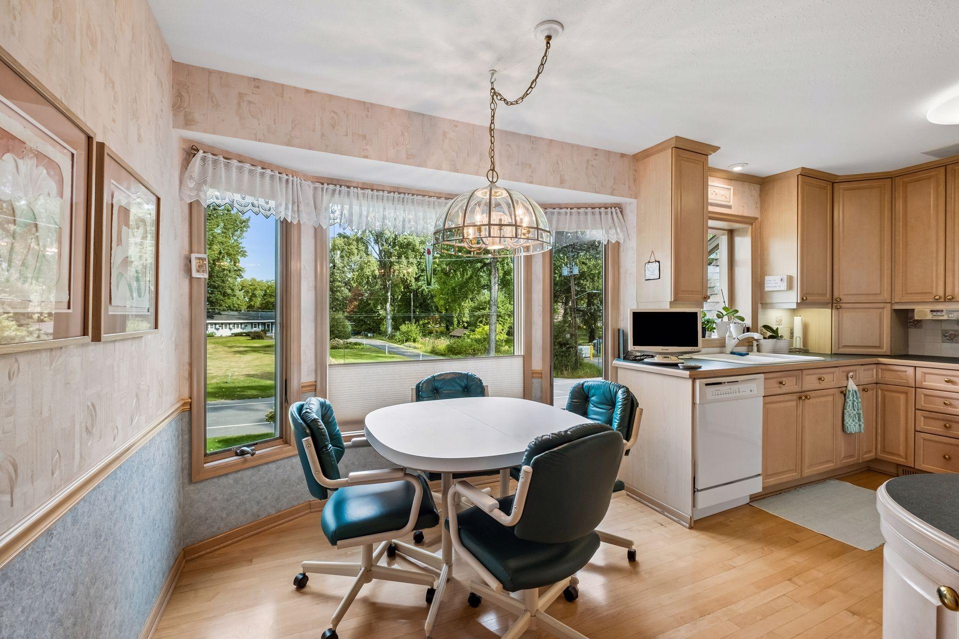 Upper level informal dining and kitchen with built-in bar with view of Medicine Lake.