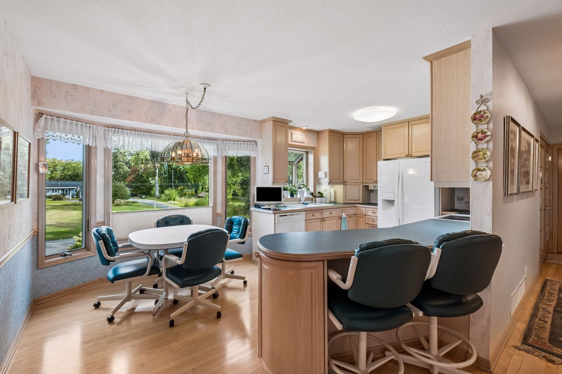 Upper level dining area with bar. Light and bright with kitchen window and tons of storage.