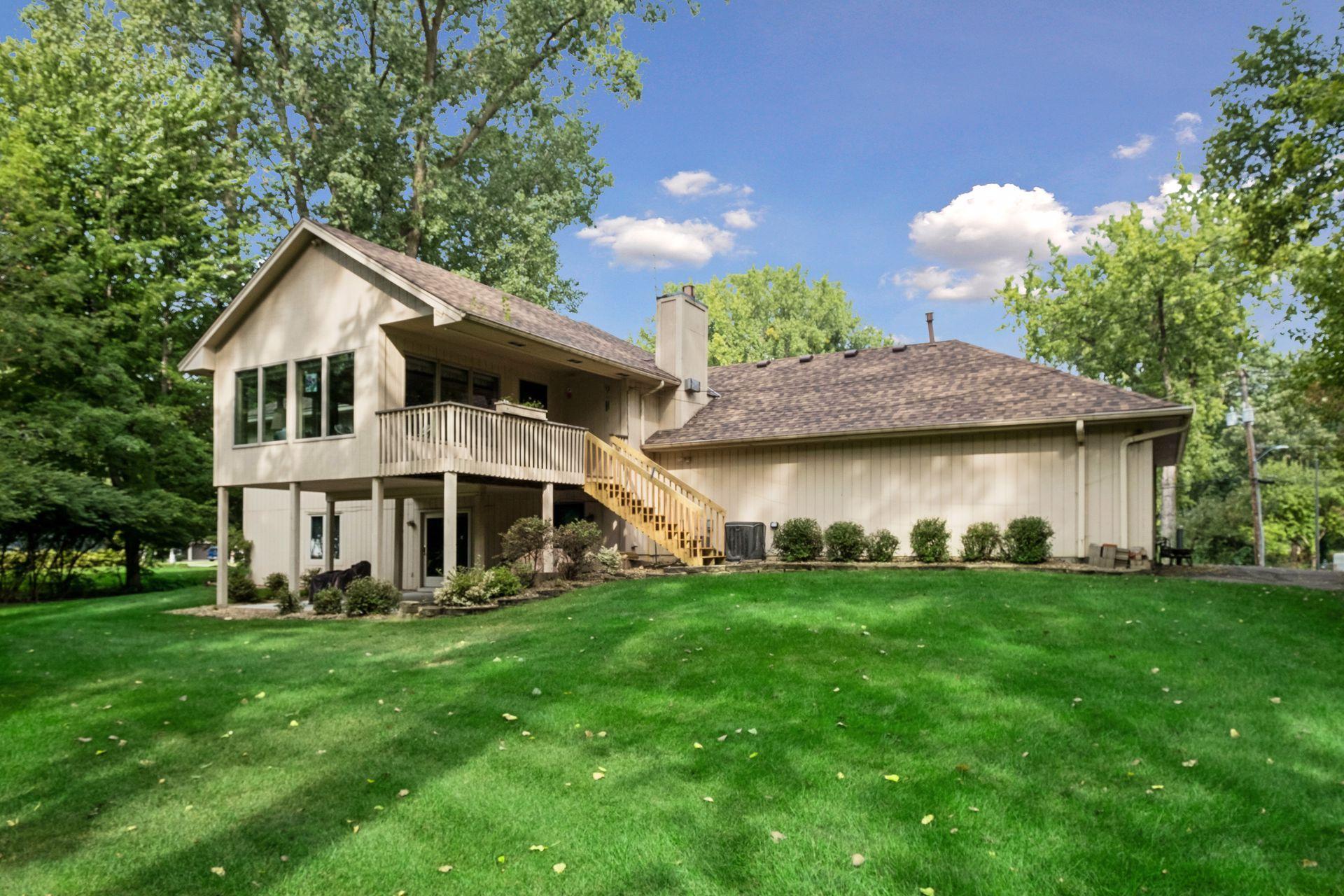 Large backyard with a deck on the upper level and walkout patio on the lower level unit.