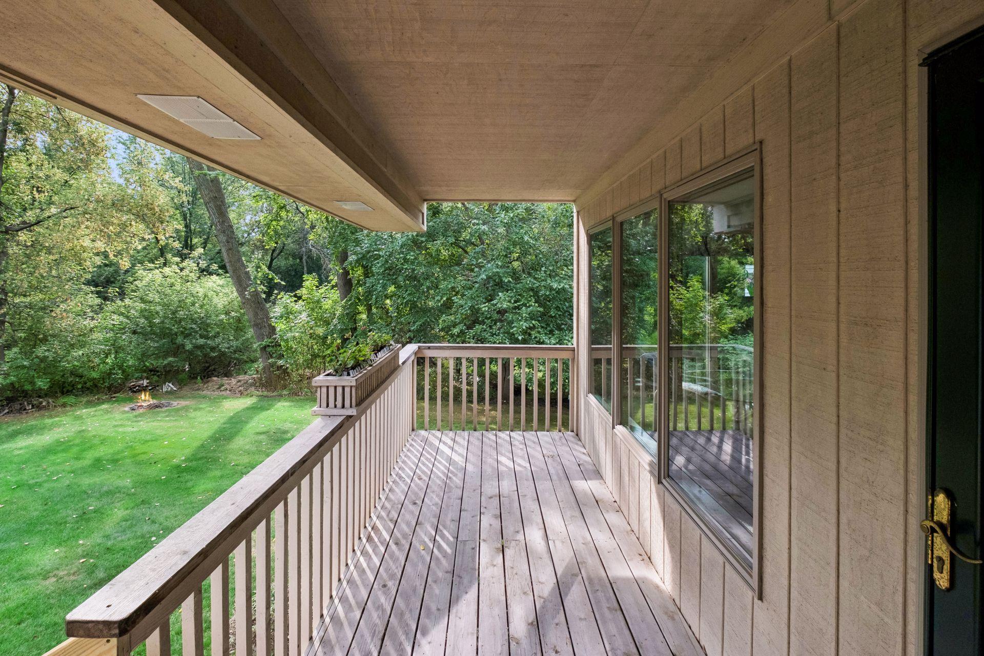 Upper level deck just off the four season porch. Notice fire pit in corner of yard.