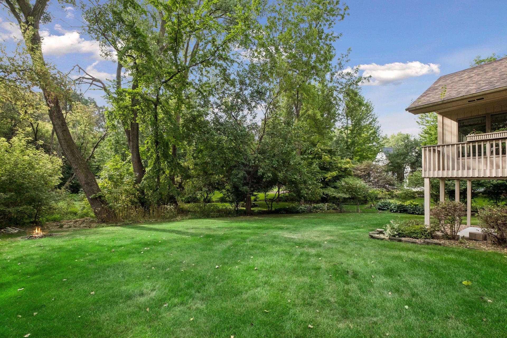 Large level and private backyard with firepit.