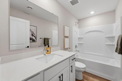 This optional third bathroom includes a vanity and shower-tub combo to bring convenience to the lower level