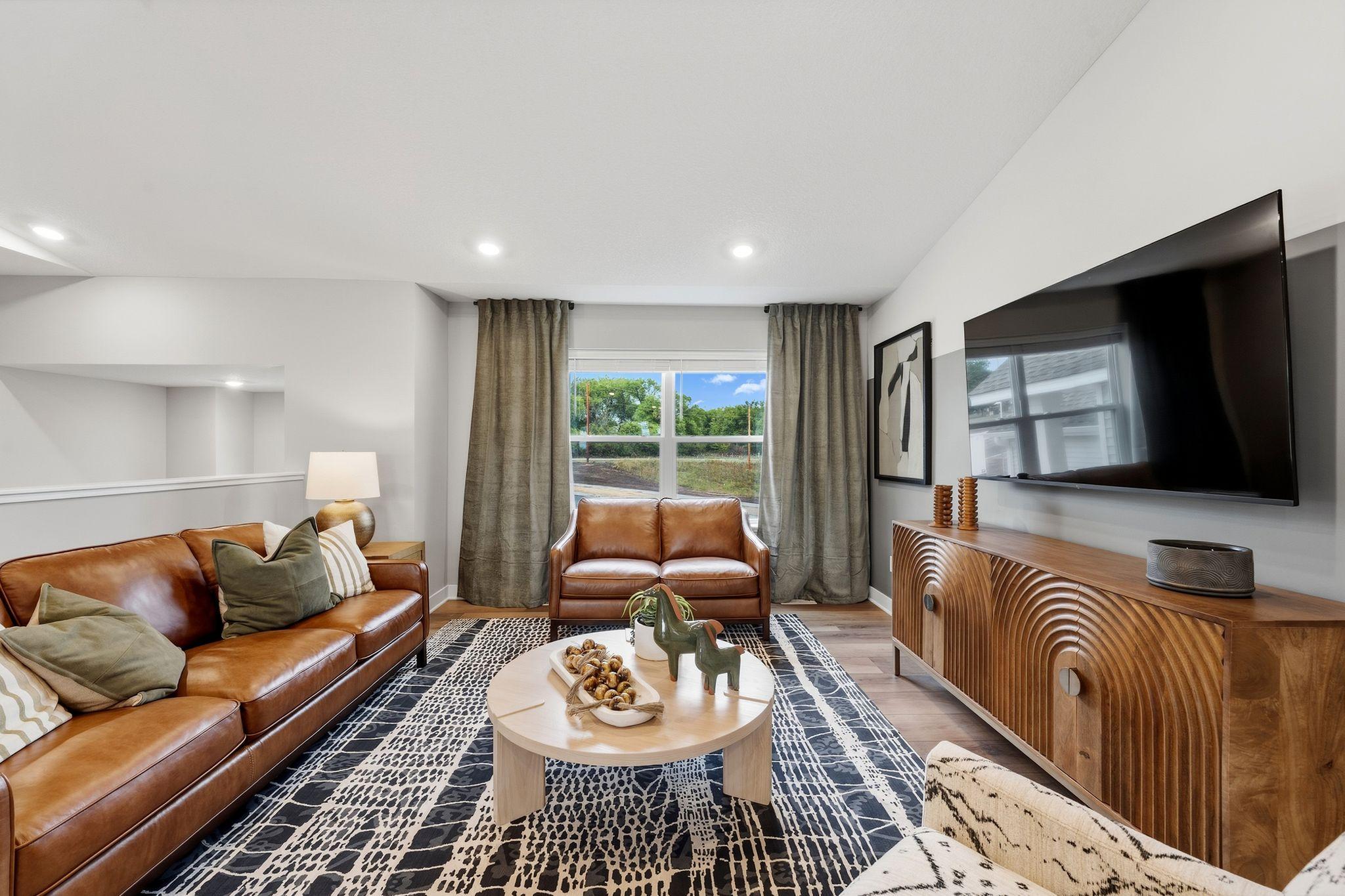 The living room immediately meets residents and guests right off the staircase