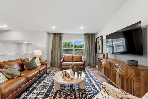 The living room immediately meets residents and guests right off the staircase