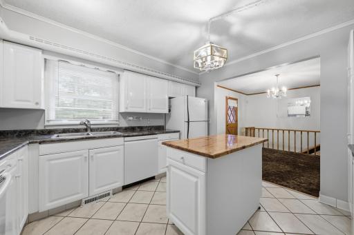Back to the kitchen overlooking the dining room. Stairs lead to the walkout level.