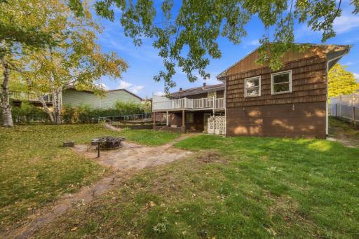 Back of home has a maintenance free deck. Exterior needs some paint on the wood cedar shakes, wood soffits and trim.