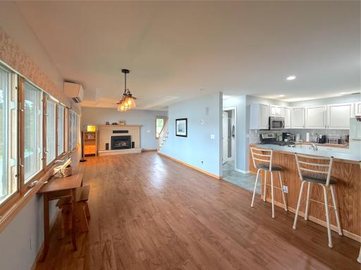 Open dining and living area flows easily from the kitchen, with expansive lakeside windows, warm pergo flooring and plenty of space to gather.