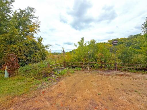 Open and level area across the road from the home offering additional parking space for overflow or a great spot for gardens.