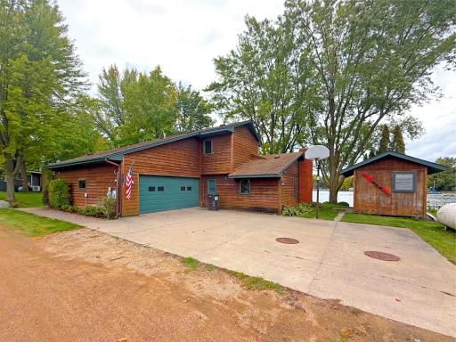 Tucked along a quiet dead-end road, the property features cedar siding, single garage and concrete driveway.