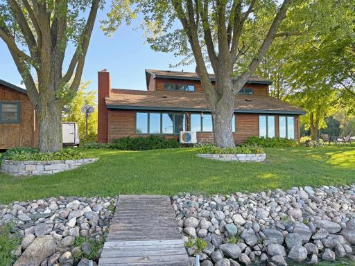 Beautiful lakeside setting with a level lawn, mature shade trees, established landscaping and an easy walk right to the waterâs edge.
