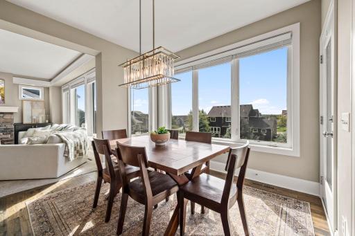 Hardwood flooring and easy deck access make this space ideal for everyday meals and entertaining.