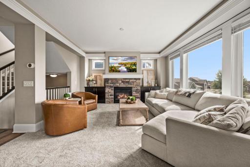 Spacious great room filled with natural light and finished with brand-new carpet.