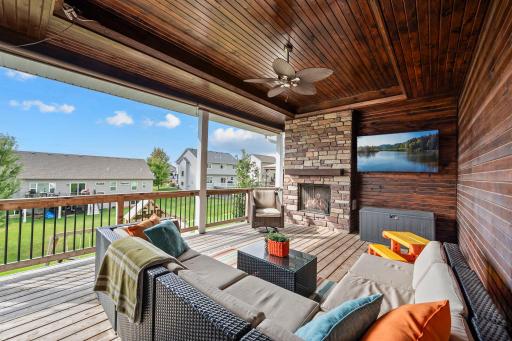 Stunning outdoor entertaining space. Open-flame gas fireplace makes the covered deck a cozy gathering spot.