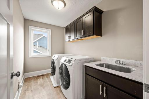 Dedicated upper-level laundry room keeps laundry conveniently close to the bedrooms.