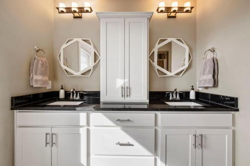 Private primary suite offers a relaxing retreat with an impressive luxury bath. Spa-inspired primary bath with a spacious double-sink vanity and private water closet.