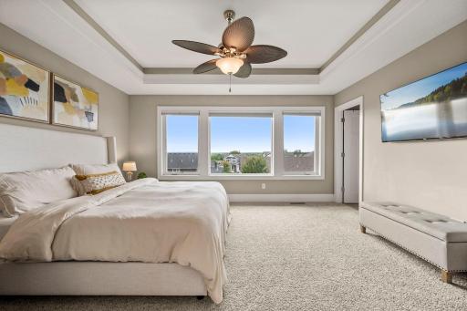 Spacious primary suite features oversized west-facing windows and abundant natural light.