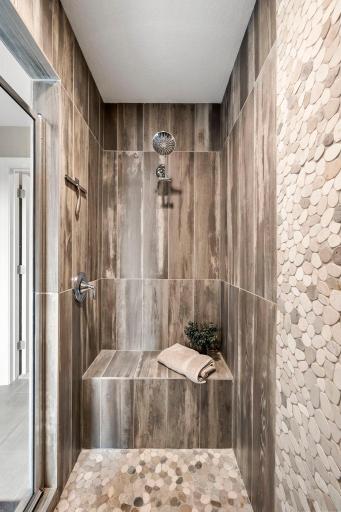 Impressive walk-in tiled shower features dual shower heads positioned at opposite ends.