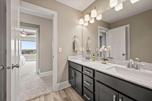 Separate enclosed toilet and shower area makes the upper-level bath especially functional.