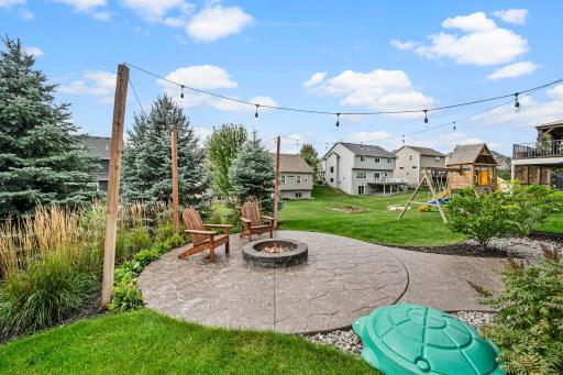 Stamped-concrete patio provides additional space for outdoor dining and relaxation.