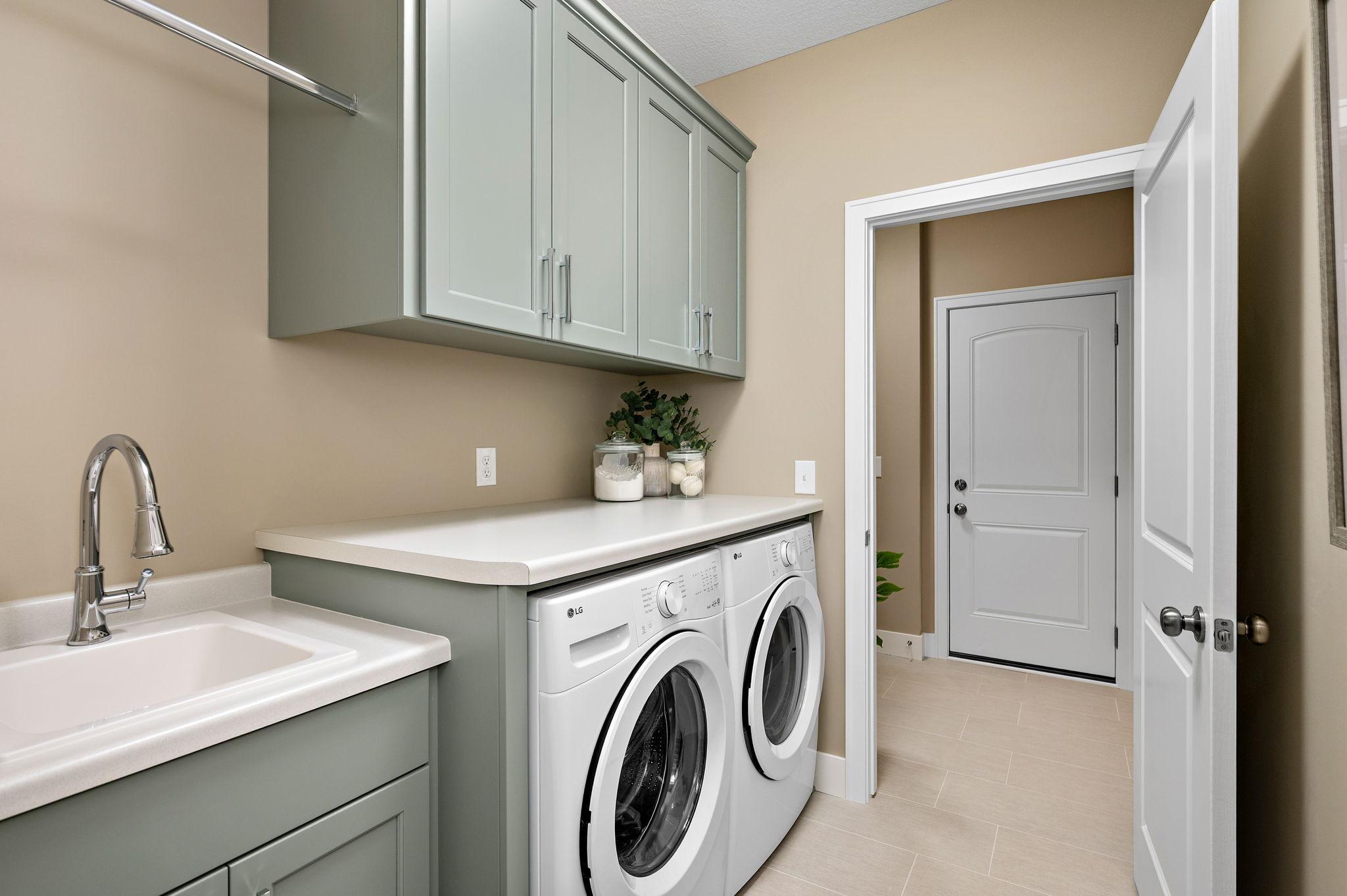 Main level laundry with builtins for storage.