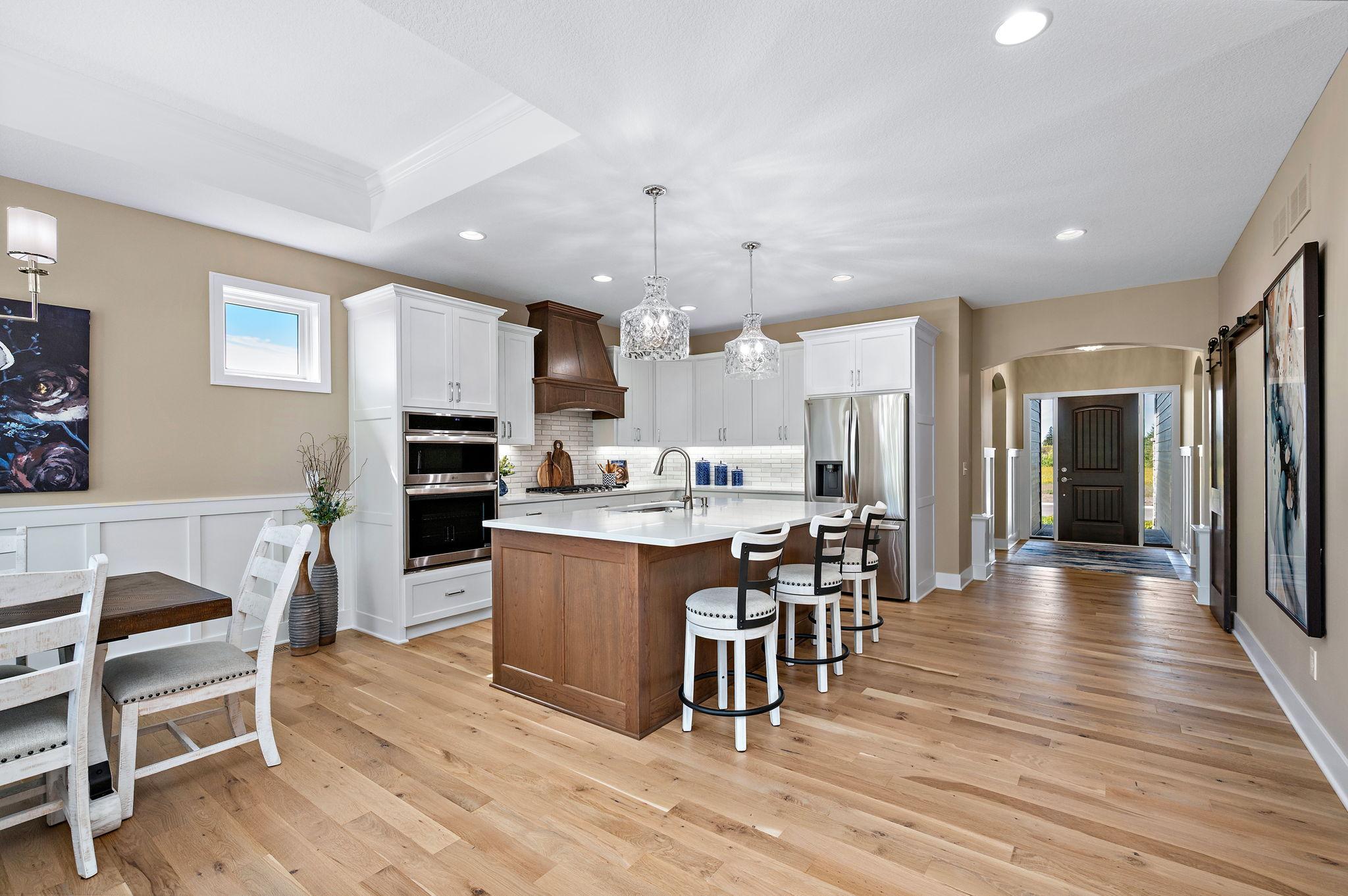 Arched front entry with wainscotting and much of the main level is real hardwood flooring