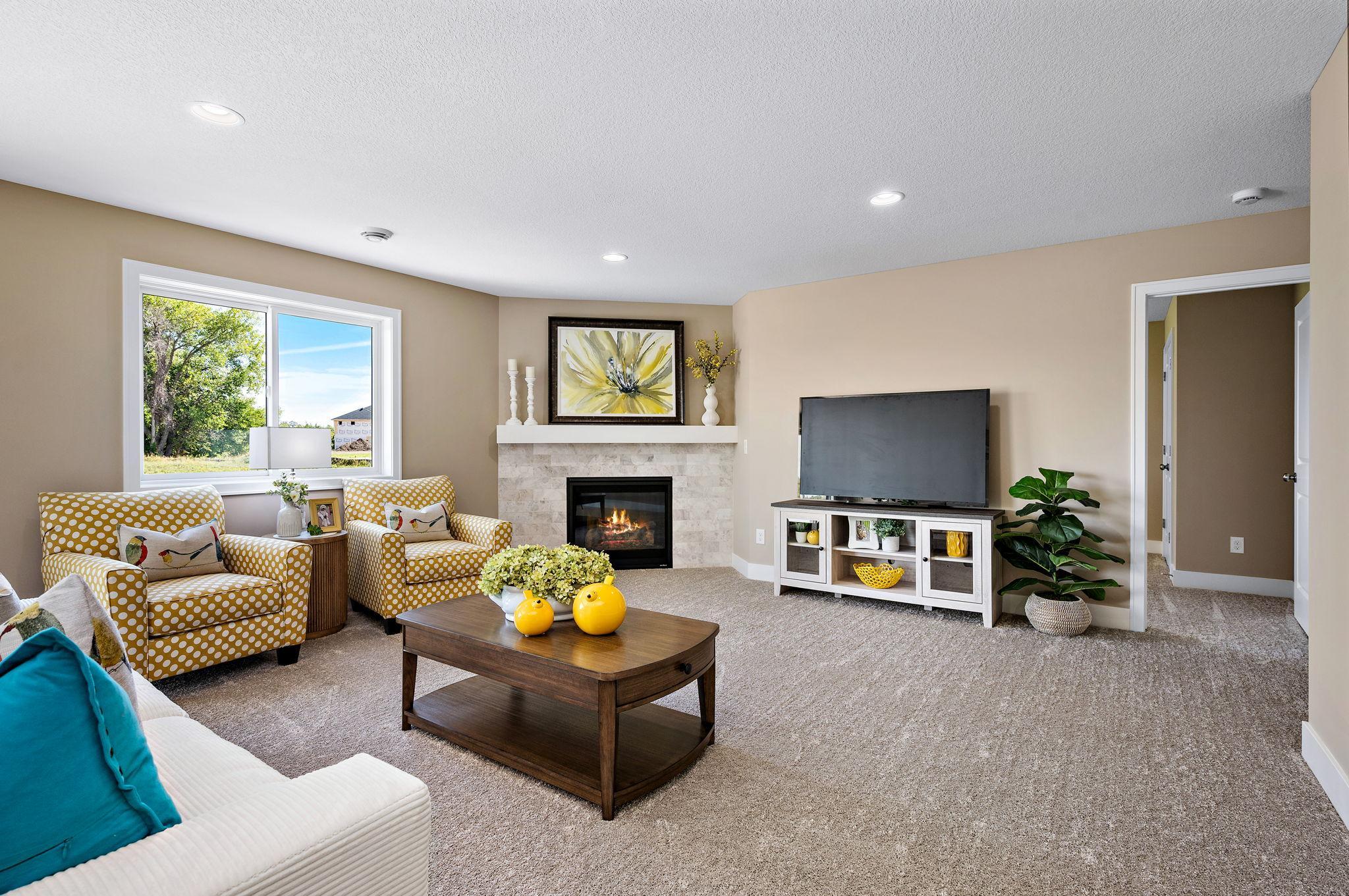 Lower level family room with stone fireplace and plenty of space for a big tv!