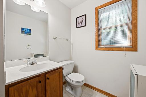 Convenient main-level half bath with a spacious vanity, large mirror, and a bright, clean finish.