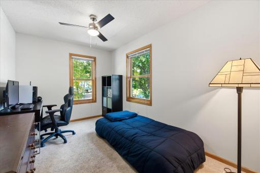 The 2nd bedroom features two large windows and space for both sleeping and dedicated work area.