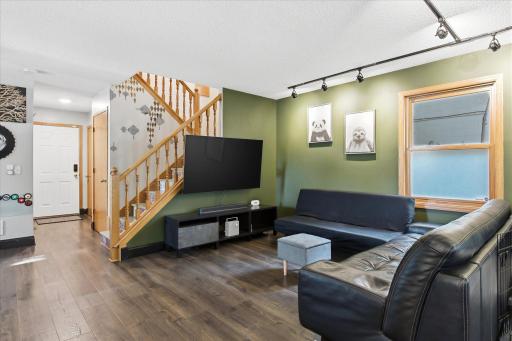 The living room is a perfect gathering space and a defined entertainment area that opens naturally to the main level.