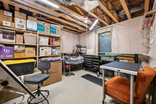 Flexible unfinished space with built-in shelving, work surfaces, and room to accommodate a variety of hobbies, projects, or organizational needs.