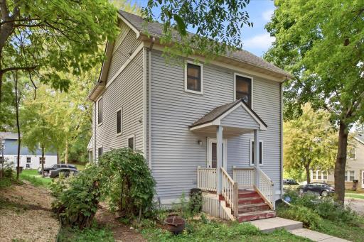 This is a well-positioned home with mature greenery, a private-feeling setting, and convenient access to the rear entry.