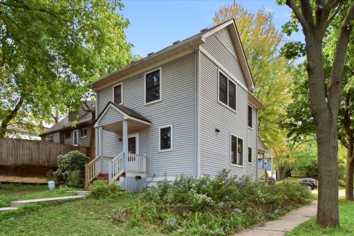 This is a very charming two-story home surrounded by mature trees with a convenient rear entry providing direct access toward the detached garage.