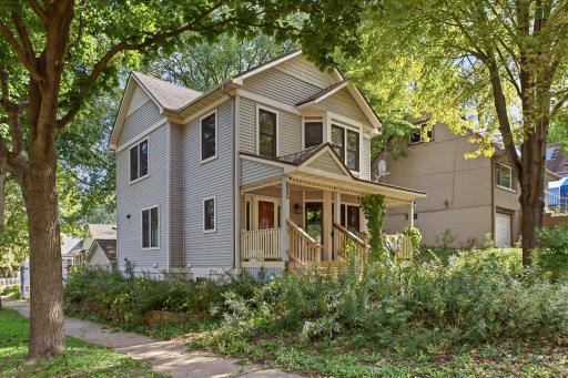 A closer look at the homeâs classic character, surrounded by mature landscaping and natural beauty.
