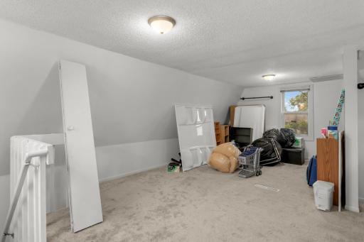 Upper-level bedroom w/ ample space to add a primary suite/2nd bath