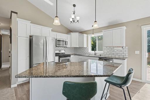 Spacious kitchen with stainless steel appliances and granite counter tops and center island!