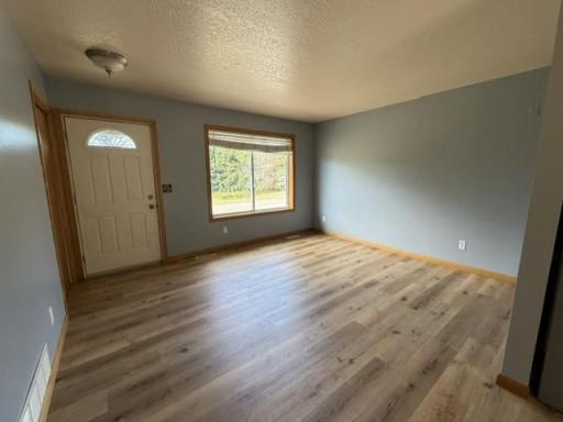 Front Foyer and living room on main level with a large picture window