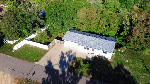 Surrounded by Mature Trees, a privacy fence and a large driveway and a cement pad in the backyard for boat or toy storage.