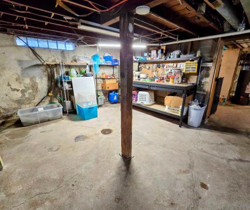 Unfinished basement area with workshop area